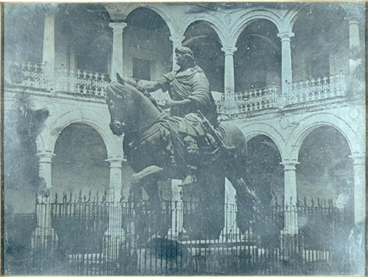
								Monument to Charles IV: El Caballito, courtyard of the Real y Pontificia Universidad de México, Jean Prelier, circa 1839-1943. The original image is mirror-flipped, but here it was placed according to the actual position.
							